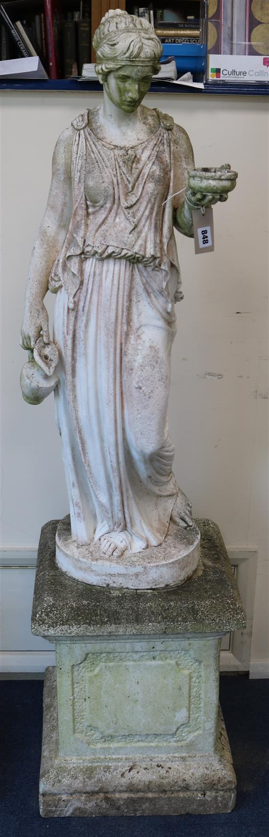 A reconstituted stone garden figure of Hebe holding a bowl and a jug, raised on square plinth W.40cm